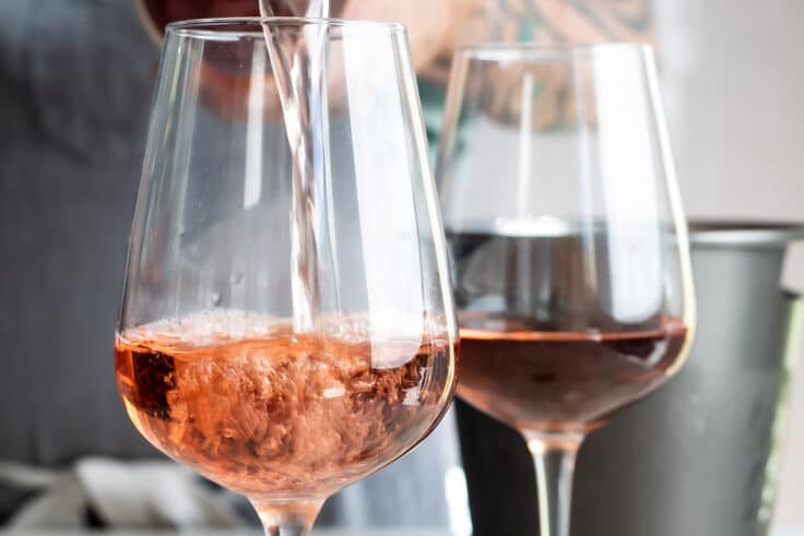 Rosé wine being poured into a glass.