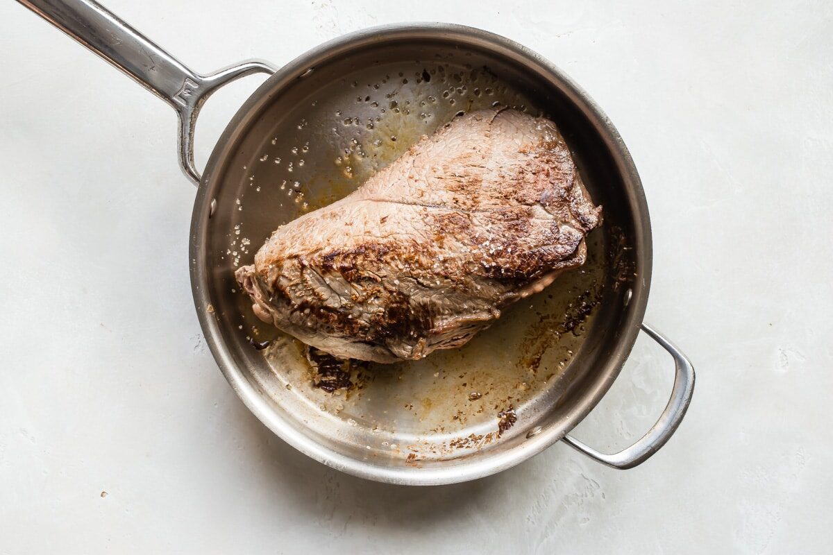 A roast browned in a skillet for beef ragu.