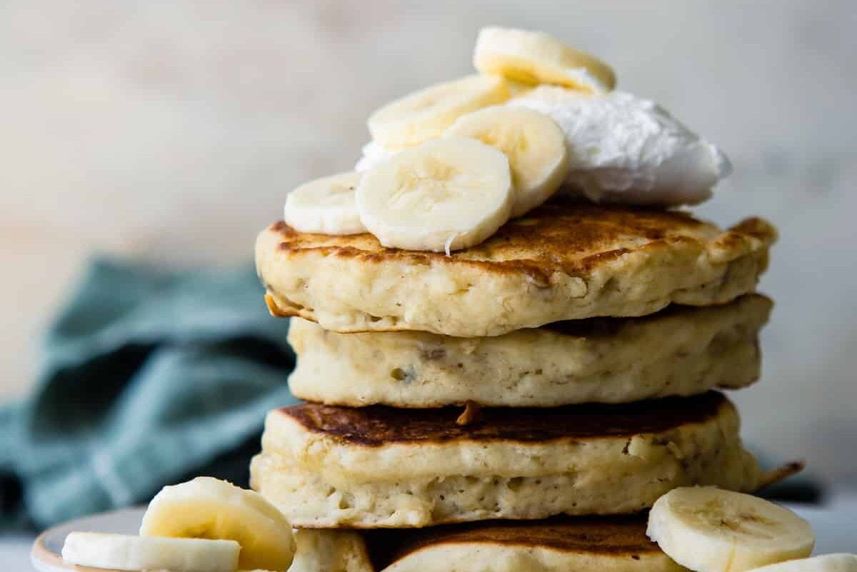 A stack of banana pancakes on a plate.