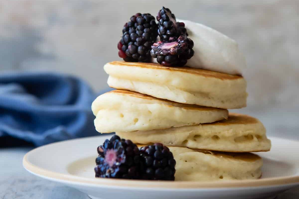 A stack of buttermilk pancakes on a plate.