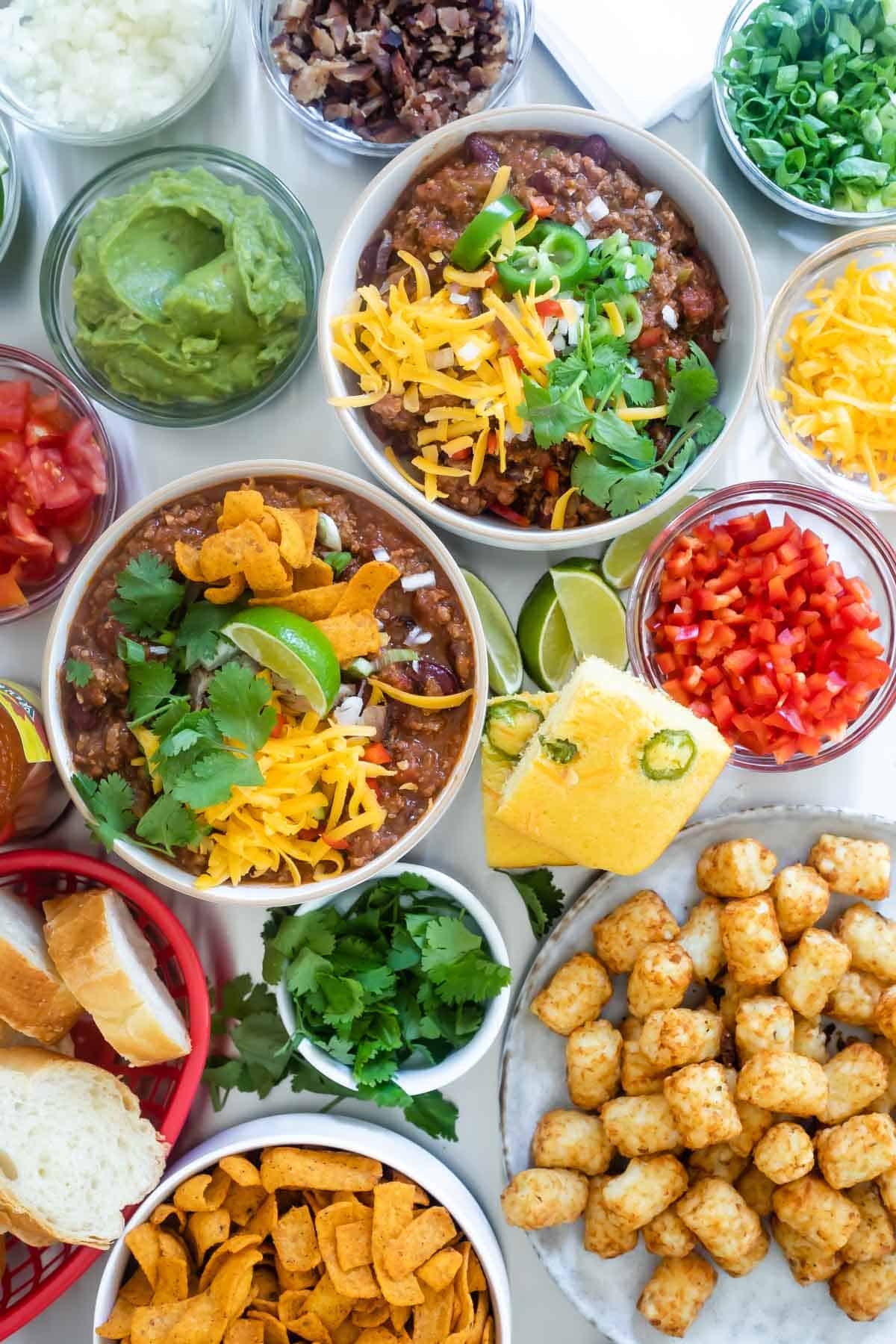 Two bowls of chili on a chili bar.