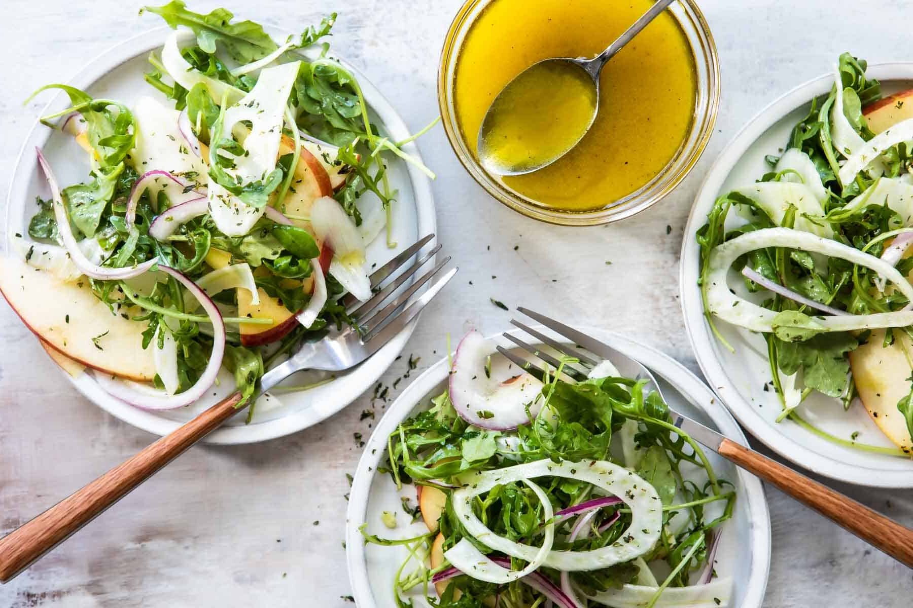 3 plates of fennel salad with apples.