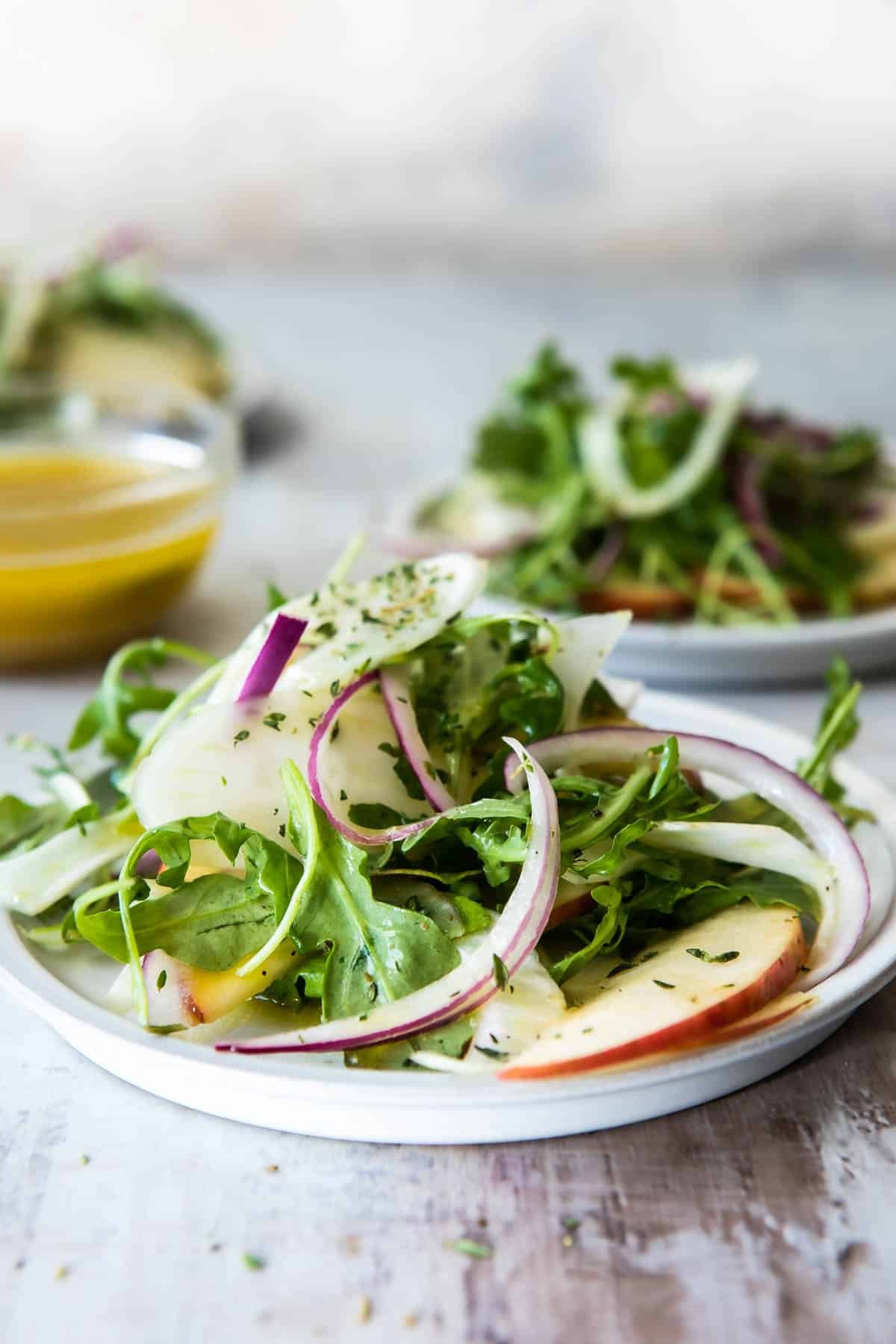 3 plates of fennel salad with apples.
