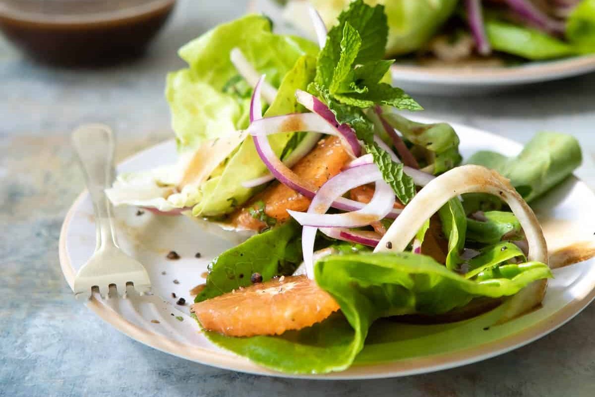 Fennel salad with oranges on a plate with a fork.