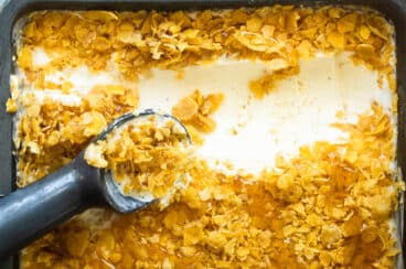 A pan of fried ice cream with an ice cream scoop in it.