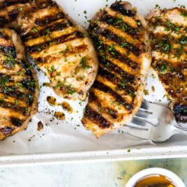 Grilled Pork Chops on a white platter.