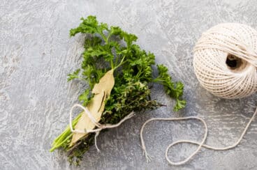 Fresh herbs with twine to make a bouquet garni.
