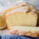 A lemon yogurt cake on a wooden cutting board.