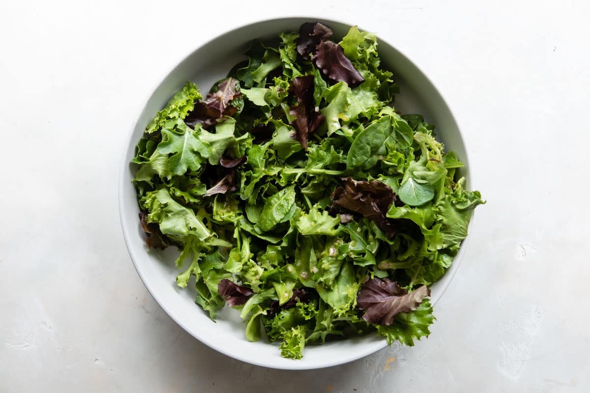 A large serving bowl with greens.