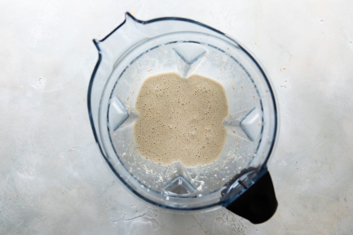 Blended oatmeal pancake ingredients in a blender.