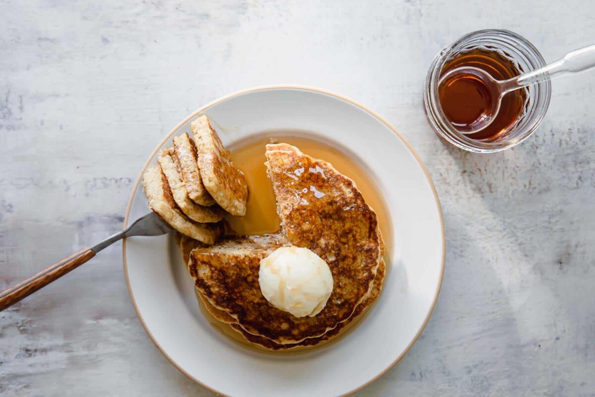 A stack of oatmeal pancakes on a plate.