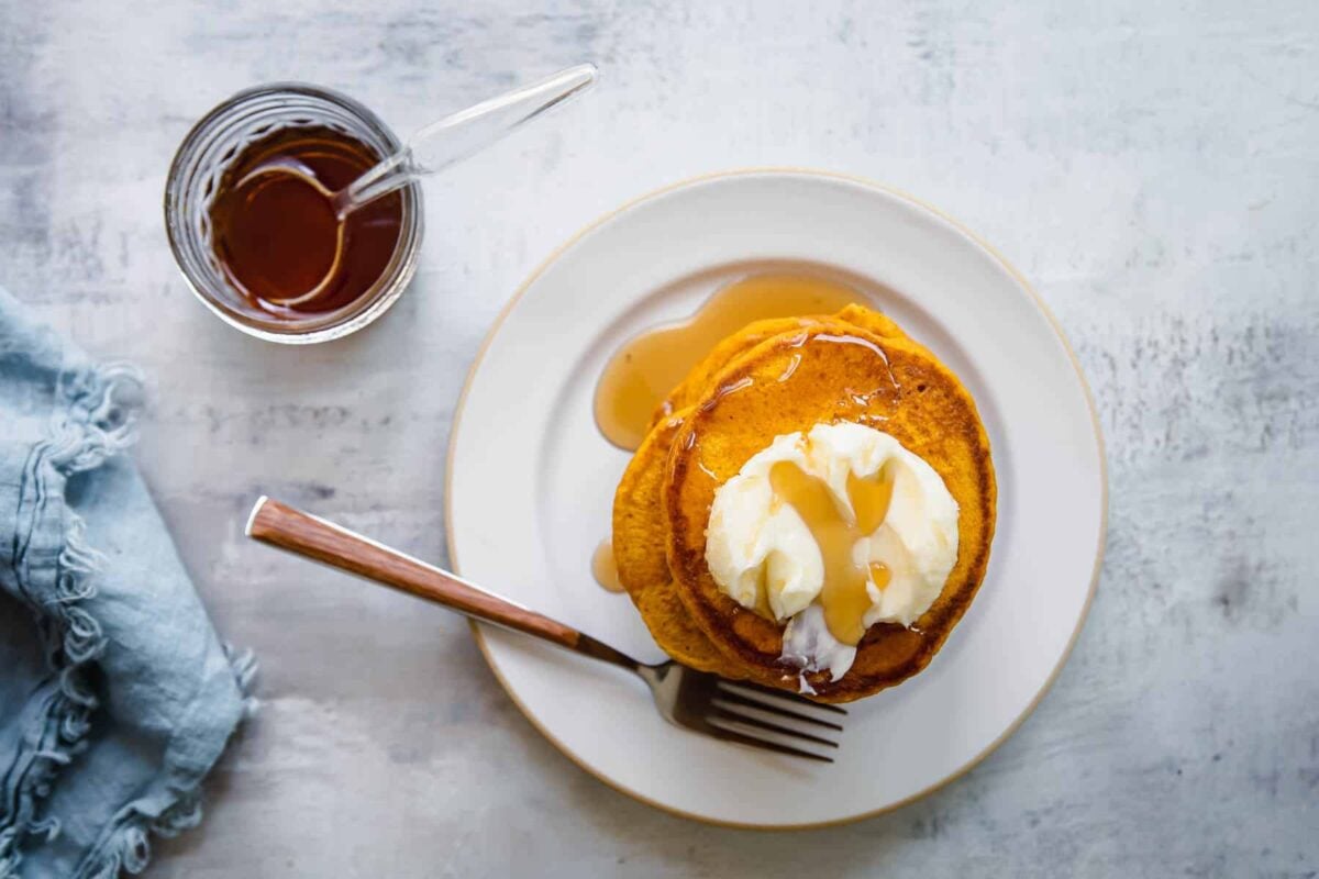 A stack of pumpkin pancakes on a plate.