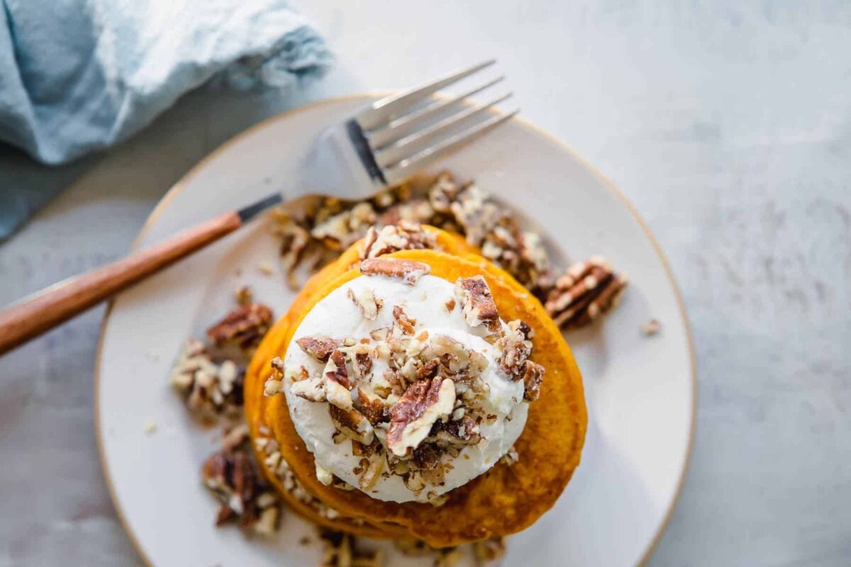A stack of pumpkin pancakes on a plate.
