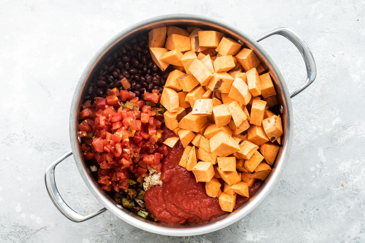 Vegetables and spices cooking in a skillet for chili.