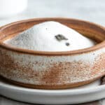 Vanilla sugar in a brown bowl.