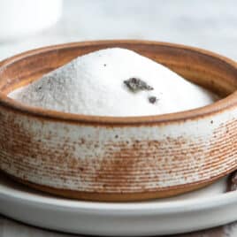 Vanilla sugar in a brown bowl.