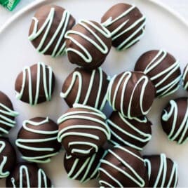 No bake mint Oreo truffles on a white plate.
