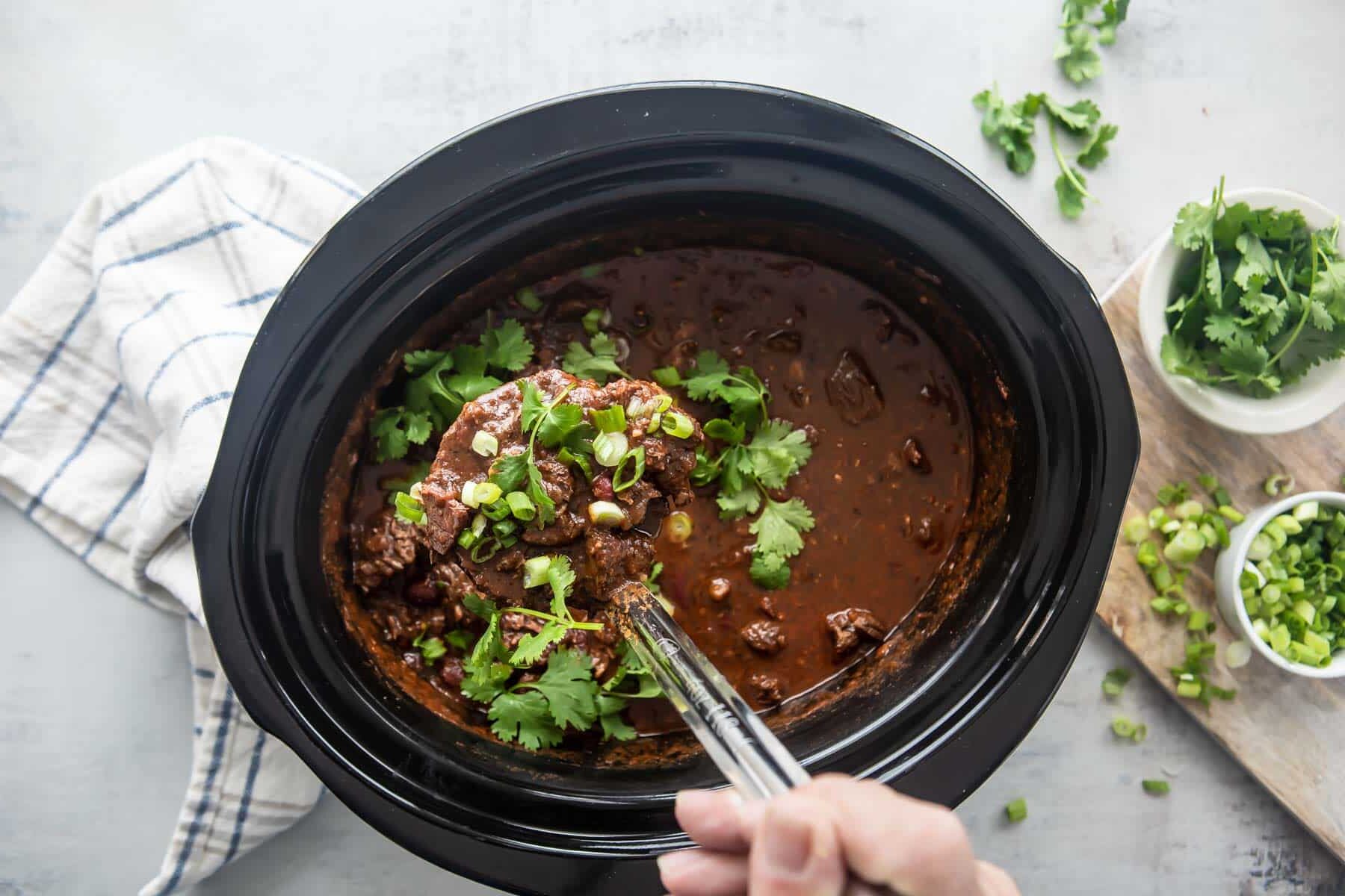 A slow cooker full of chili con carne.