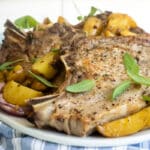 A plate with pork chops and potatoes.