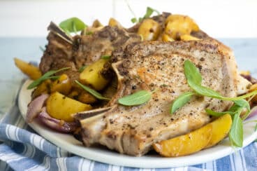 A plate with pork chops and potatoes.