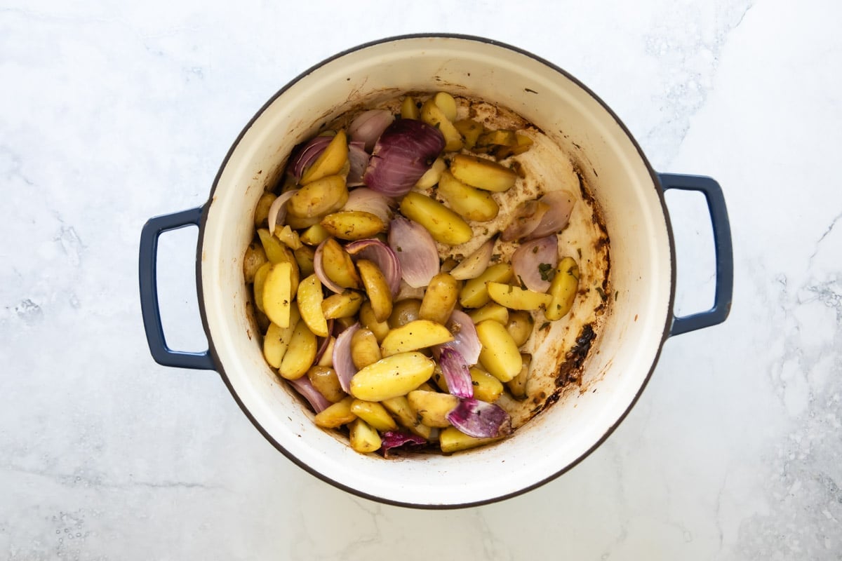 Vegetables being browned in a Dutch oven.