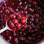 Cooking cherry pie filling in a large stock pot.