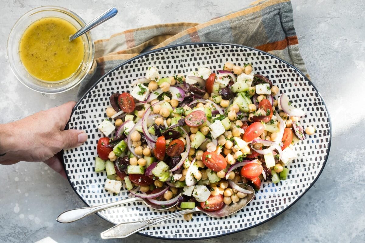 Chickpea salad on a black and white serving platter.