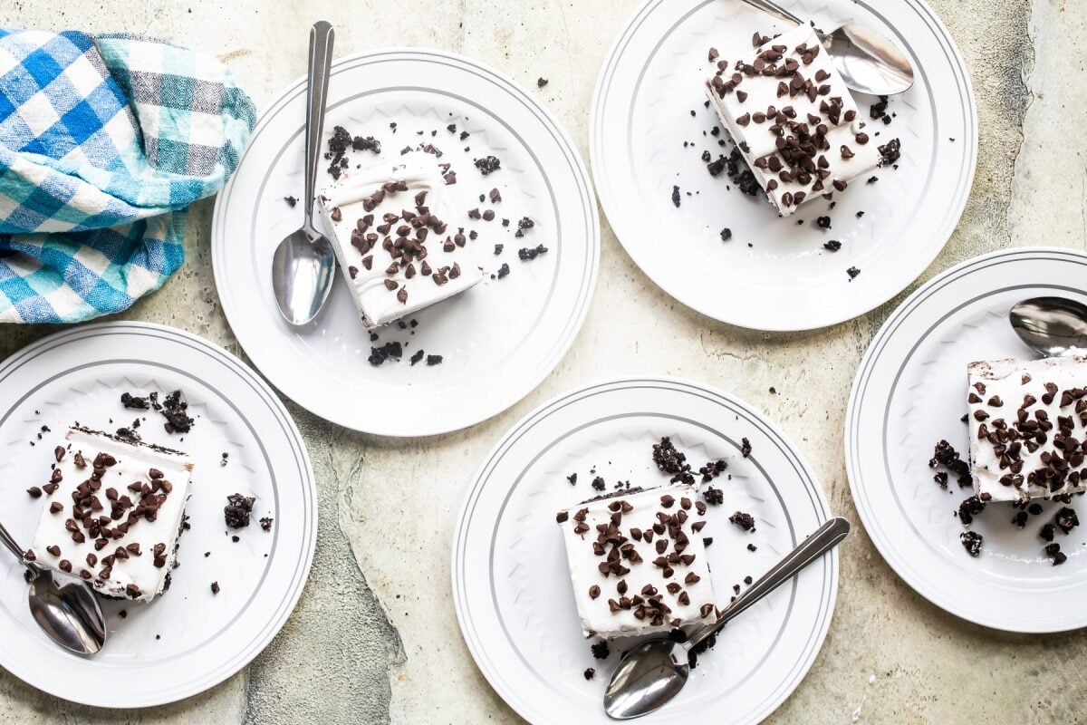 Slices of chocolate lasagna on white plates.