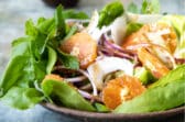 Fennel salad with oranges in a brown bowl.