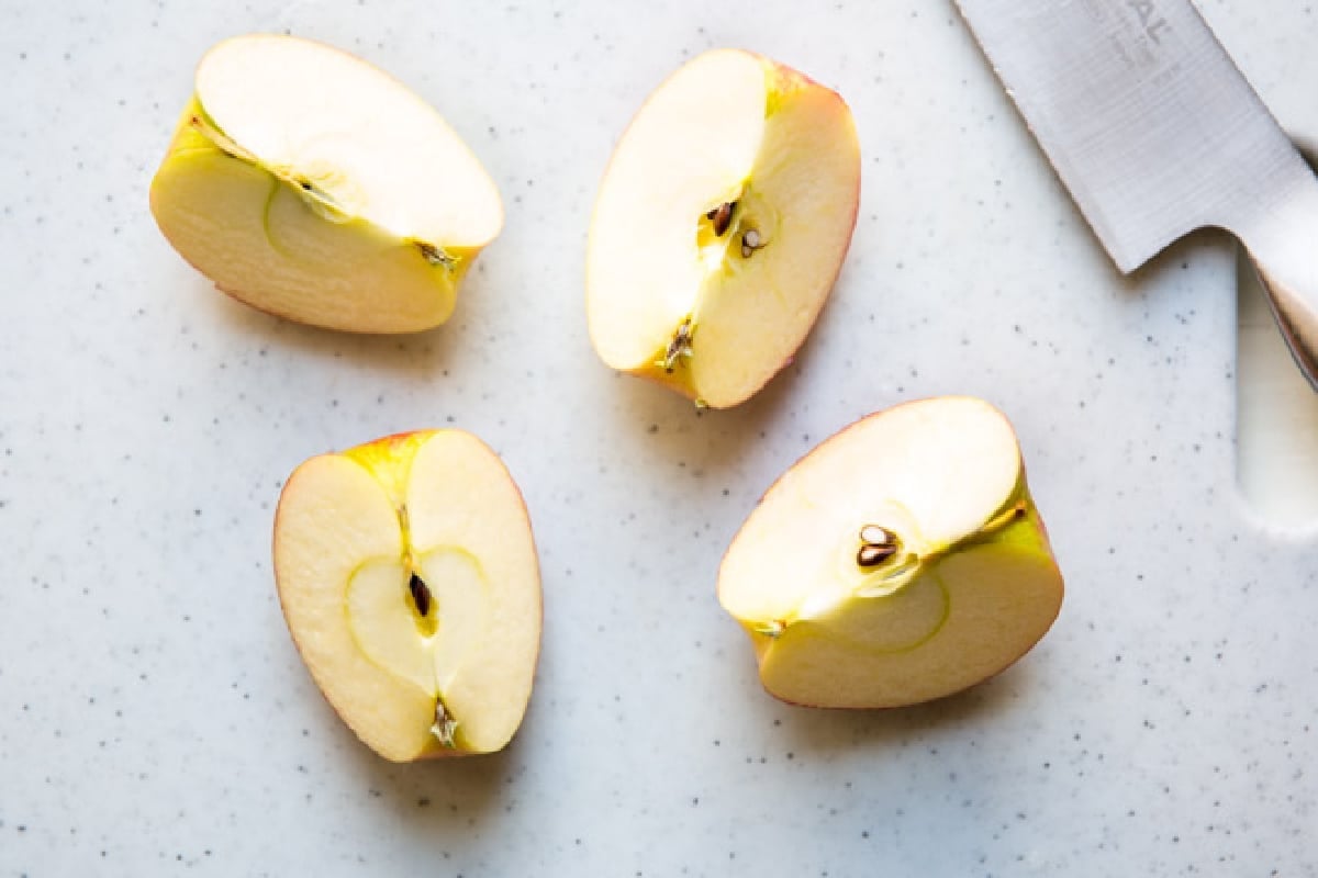 An apple cut into 4 pieces.
