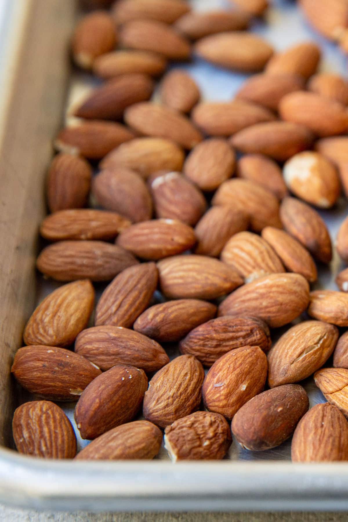 Roasted almonds on a baking sheet.