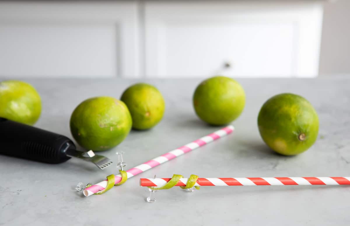 Lime twists being made on straws.