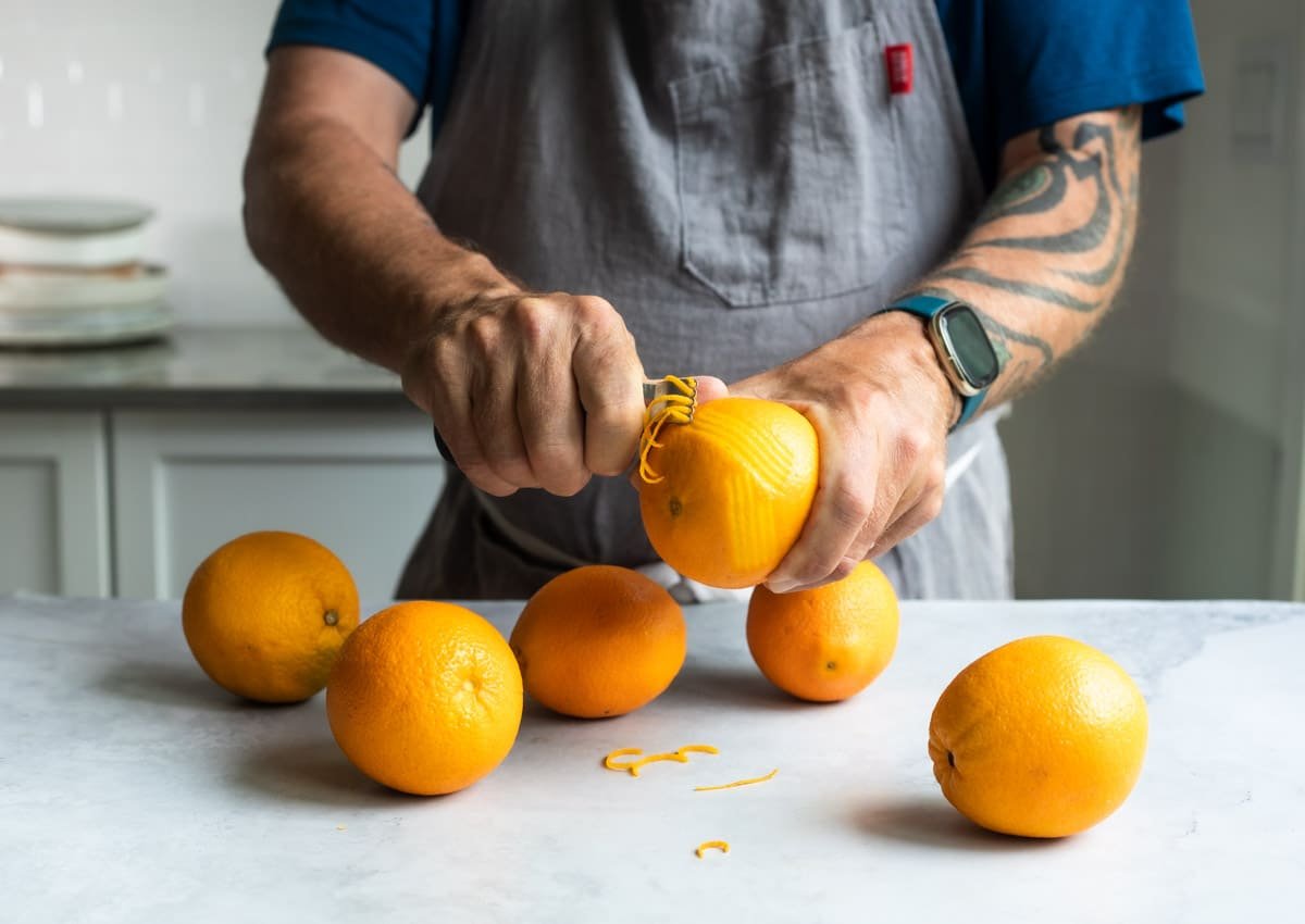 Someone zesting an orange.