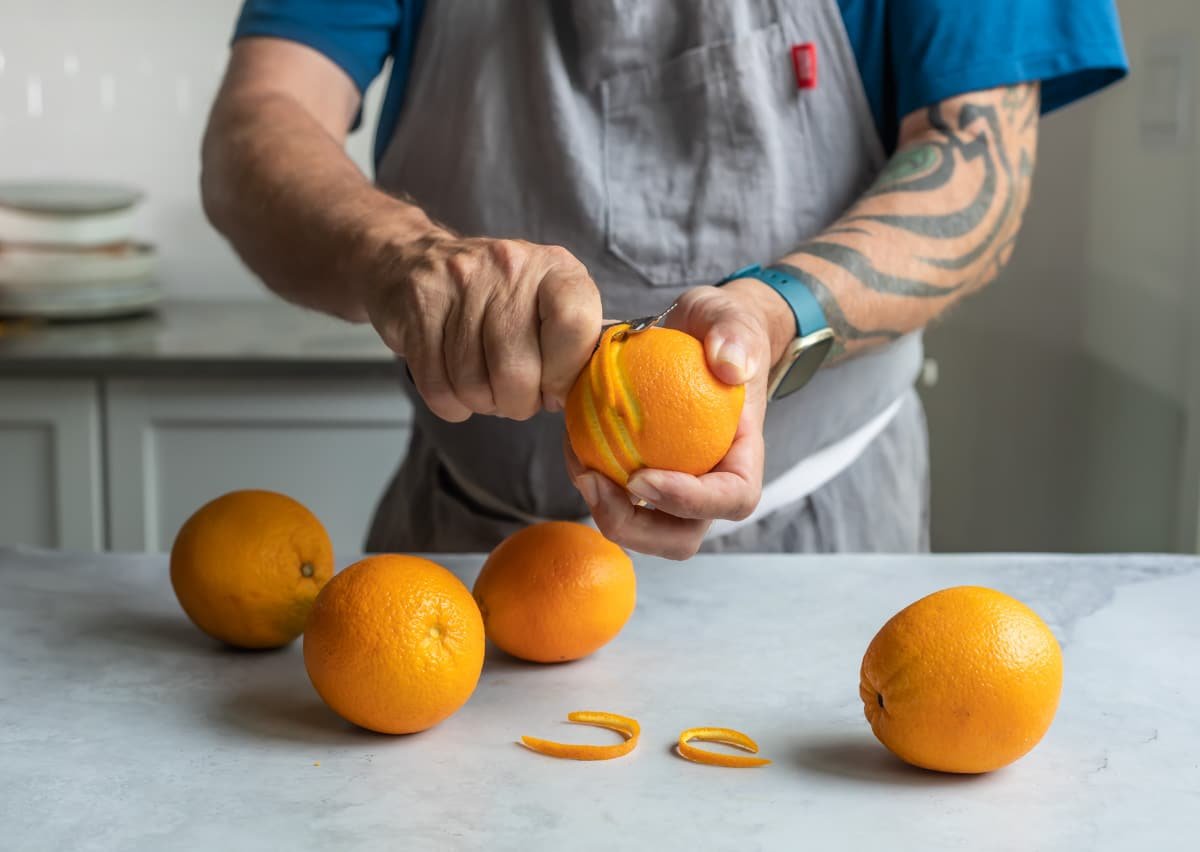 Someone zesting an orange.