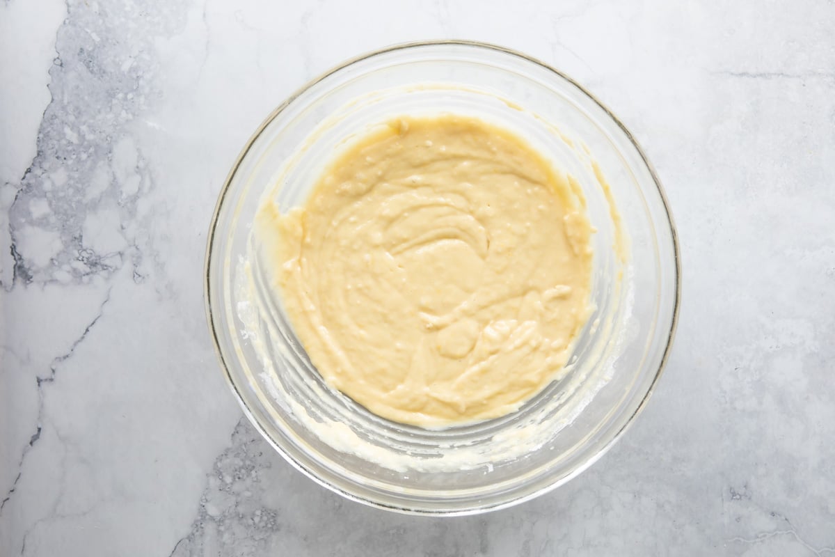 Lemon yogurt cake batter in a clear bowl.
