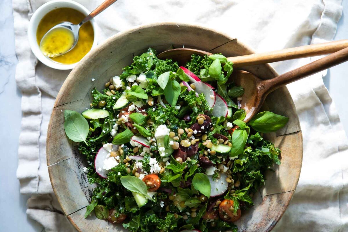 A Mediterranean Lentil salad in a wooden bowl.
