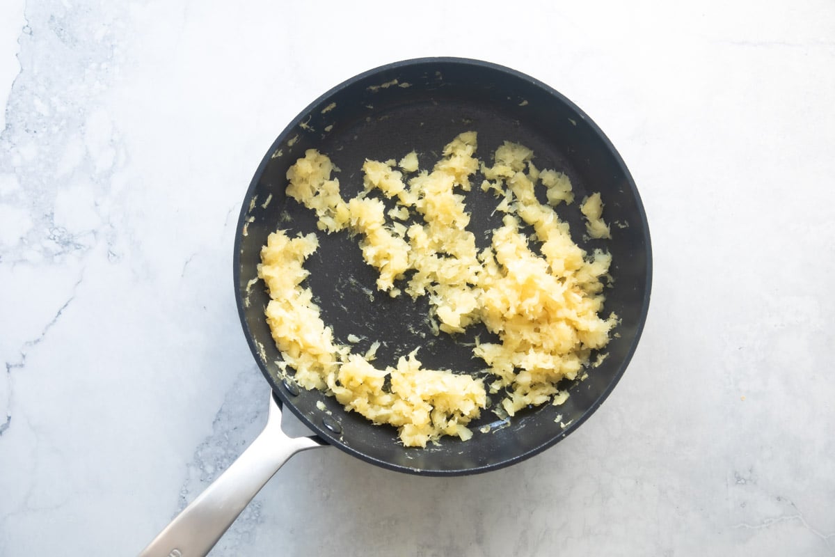 Cooking down pineapple in a skillet.