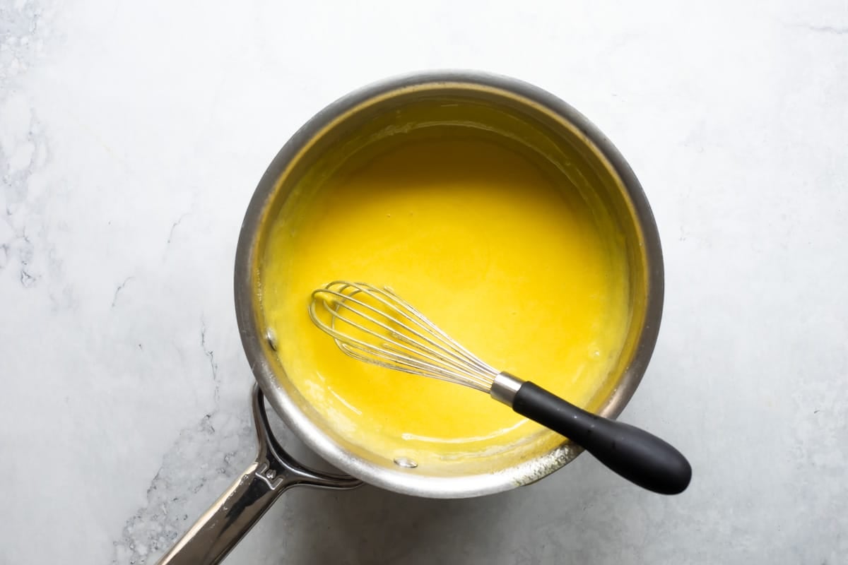Cooking the pineapple filling for millionaire pie.