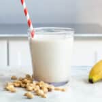 A peanut butter smoothie in a glass.