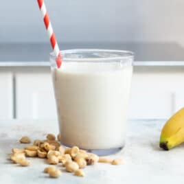 A peanut butter smoothie in a glass.