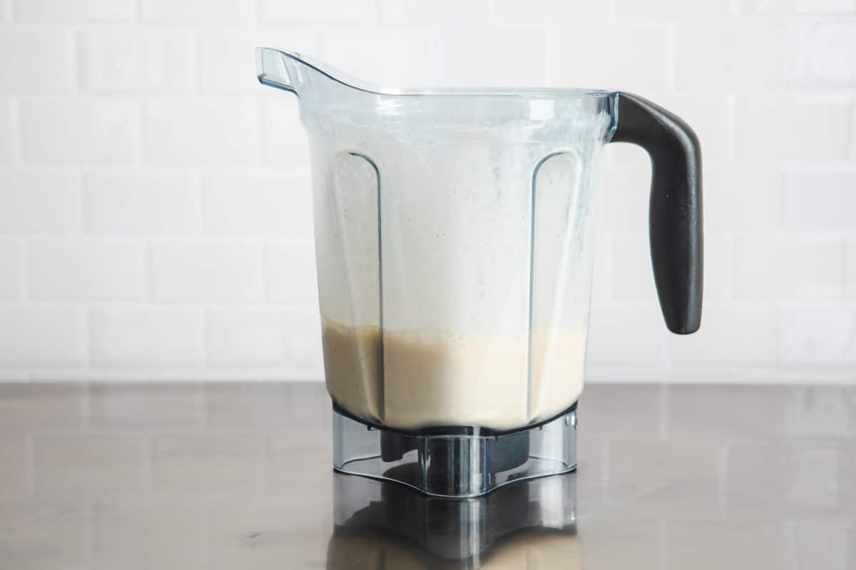Pumpkin smoothie in a blender after being blended.