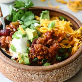 Turkey chili in a small brown bowl.