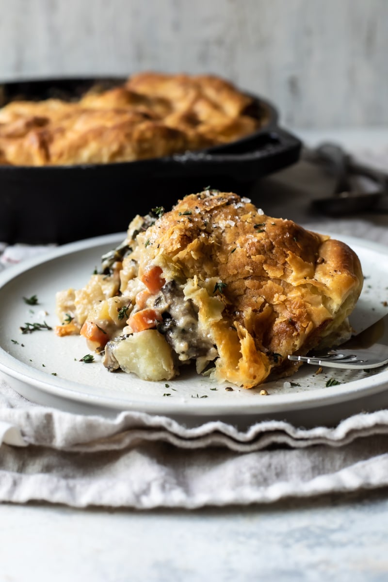 A piece of vegetable pot pie on a gray plate.