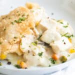 Chicken pot pie in a white dish.