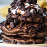A stack of chocolate pancakes on a plate.