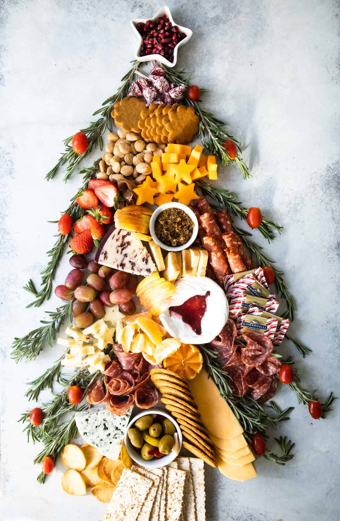 A fully-built Christmas charcuterie board shaped like a tree.