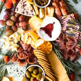 A christmas charcuterie board shaped like a christmas tree.