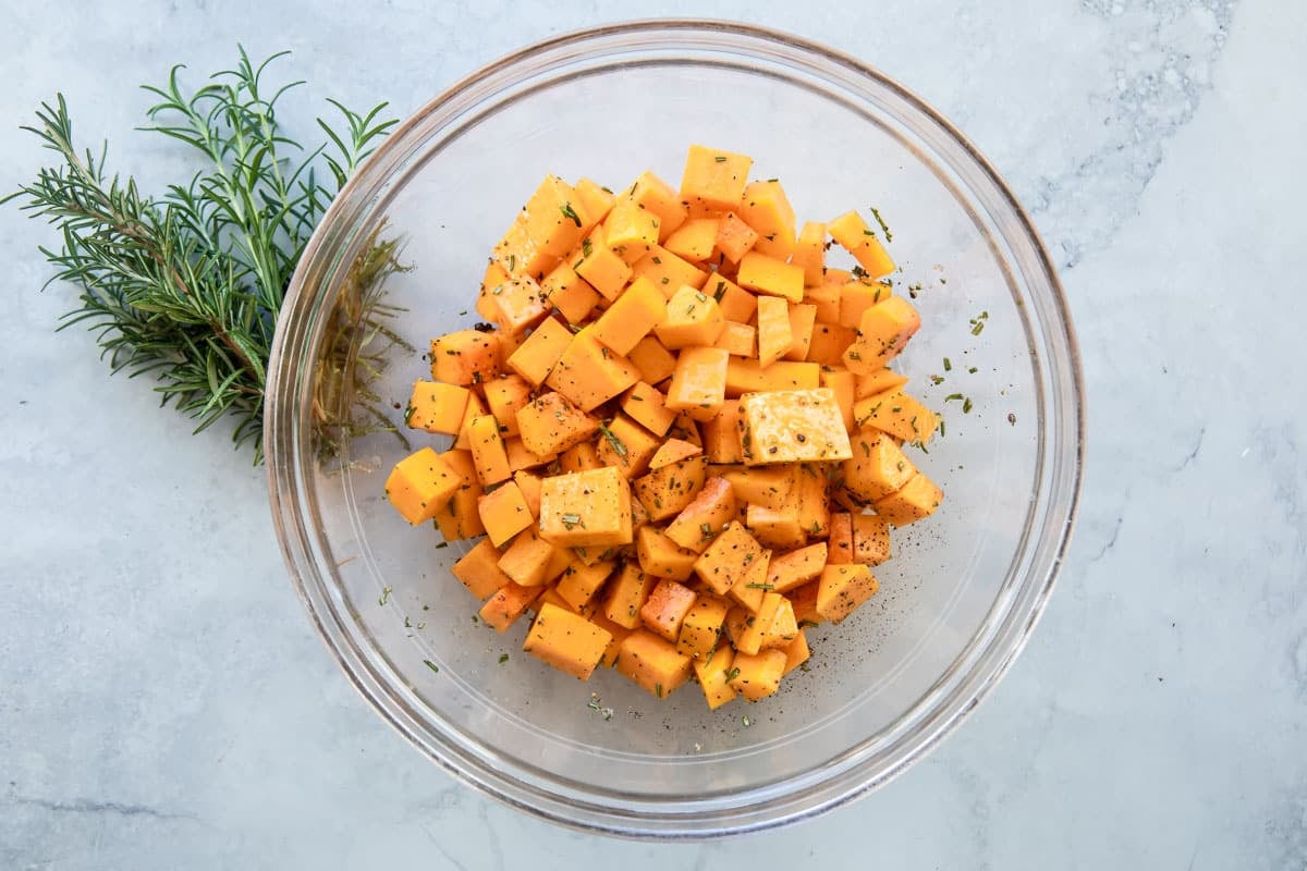 A bowl of raw butternut squash cubes.