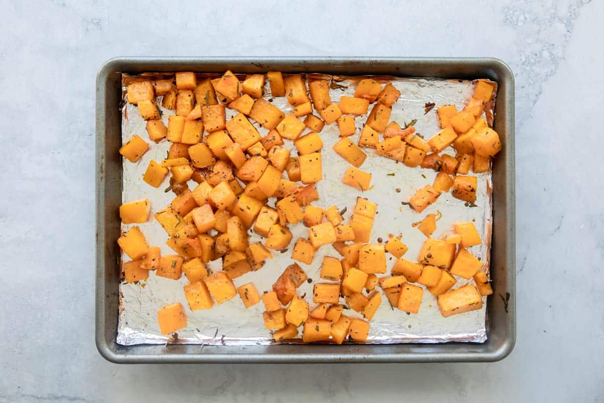 Roasted butternut squash on a baking sheet.