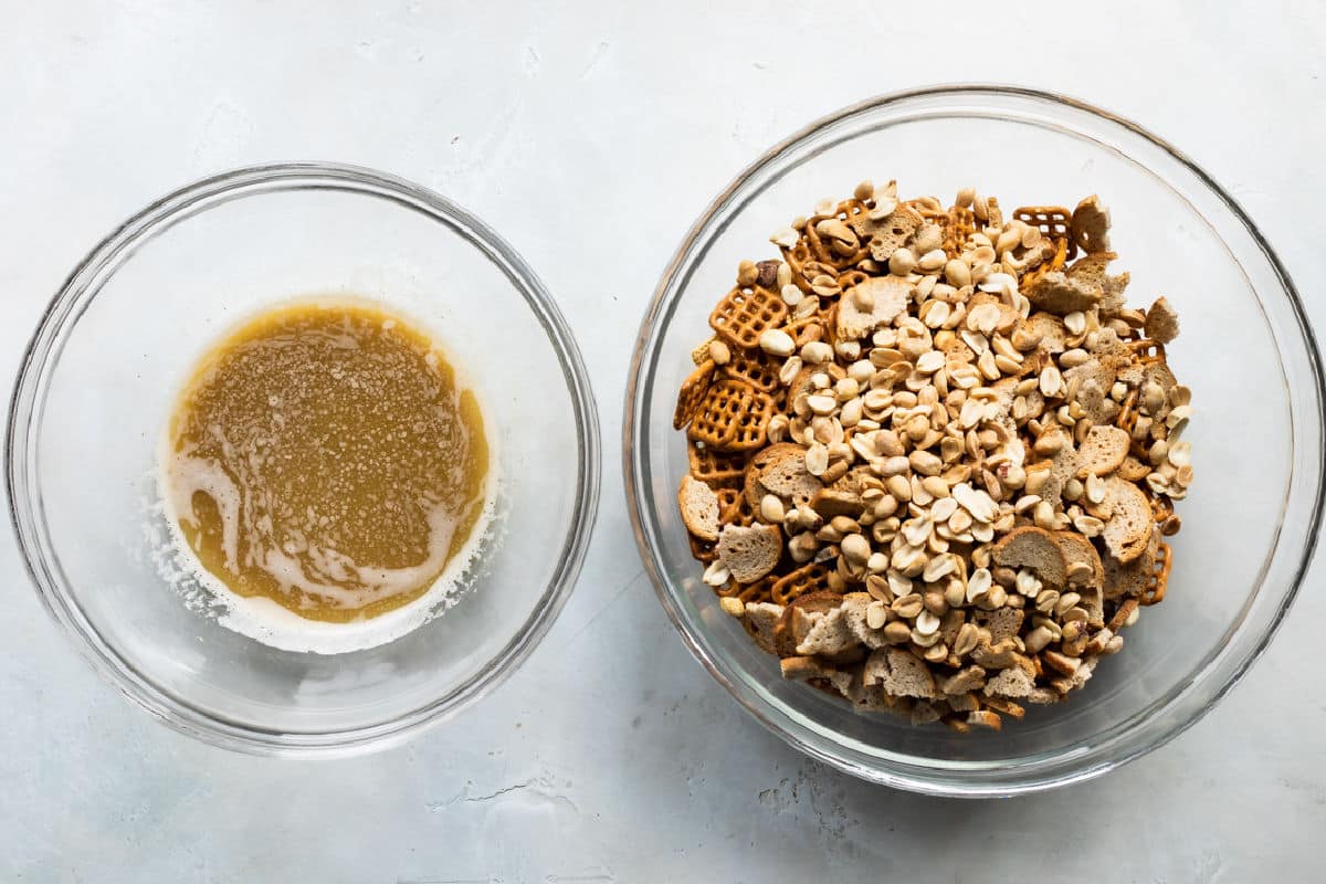 A bowl of chex mix next to the butter topping.